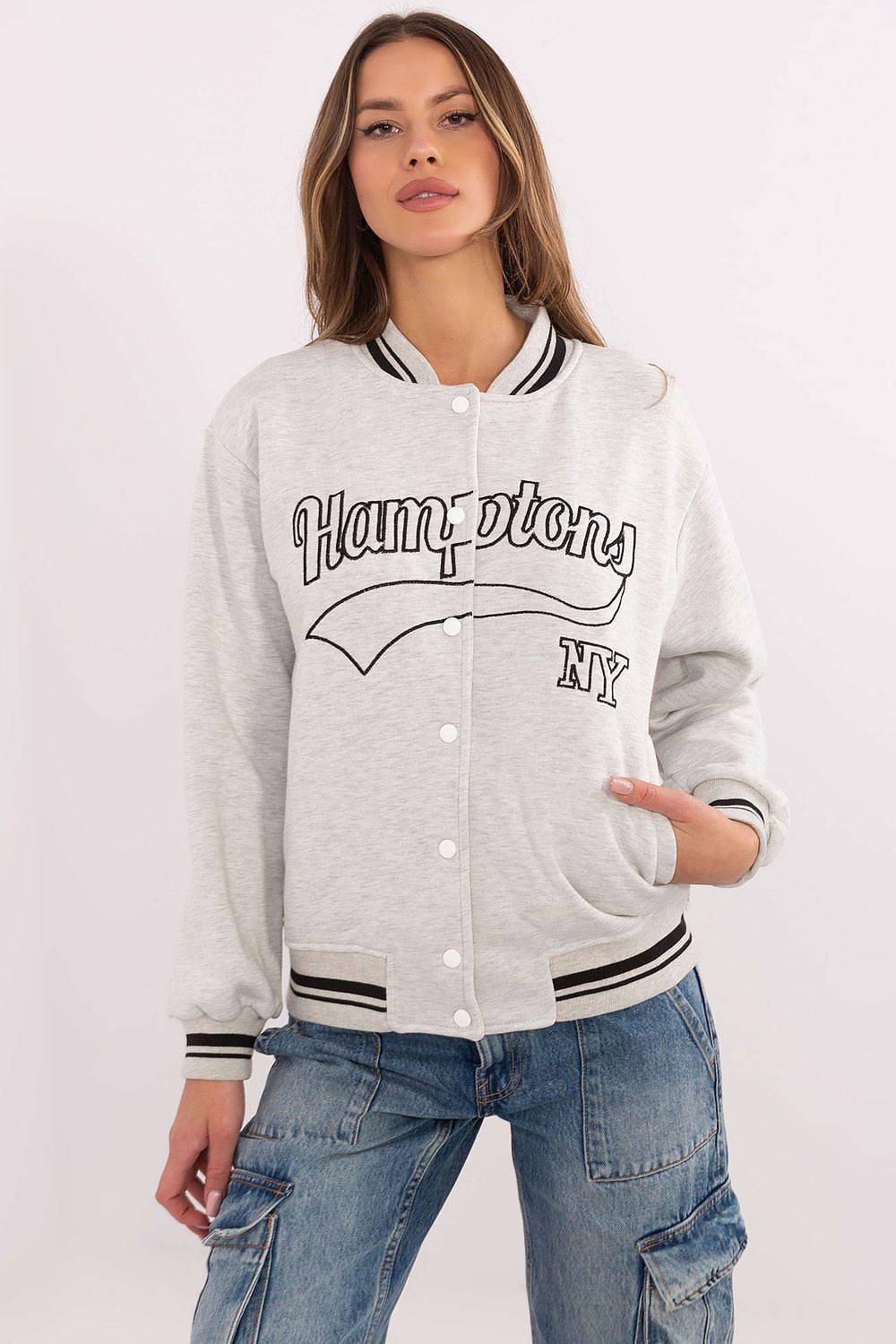 Grey Women's Bomber Jacket with black 'Hamptons NY' text, varsity-style sweatshirt with striped ribbed cuffs and front snap buttons.