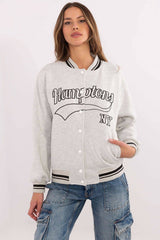 Grey Women's Bomber Jacket with black 'Hamptons NY' text, varsity-style sweatshirt with striped ribbed cuffs and front snap buttons.